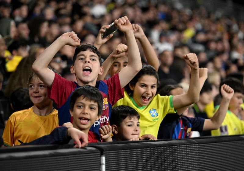 Energetic youth supporters enjoying a live soccer match at a professional stadium, showcasing the excitement and community engagement that comes with attending elite sports events. This captures the passion for soccer that Incasadm fosters through their sports event experiences.